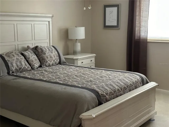 a bedroom with a bed and window