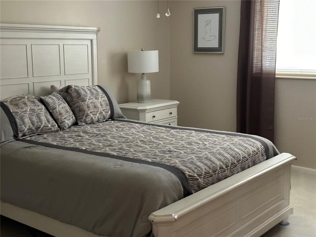 8680 Southwest 94 Lane, Unit G Ocala, FL 34481 - Photo 19 of 24 a bedroom with a bed and window