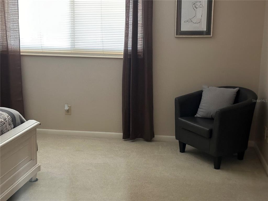 8680 Southwest 94 Lane, Unit G Ocala, FL 34481 - Photo 21 of 24 a living room with furniture and a window