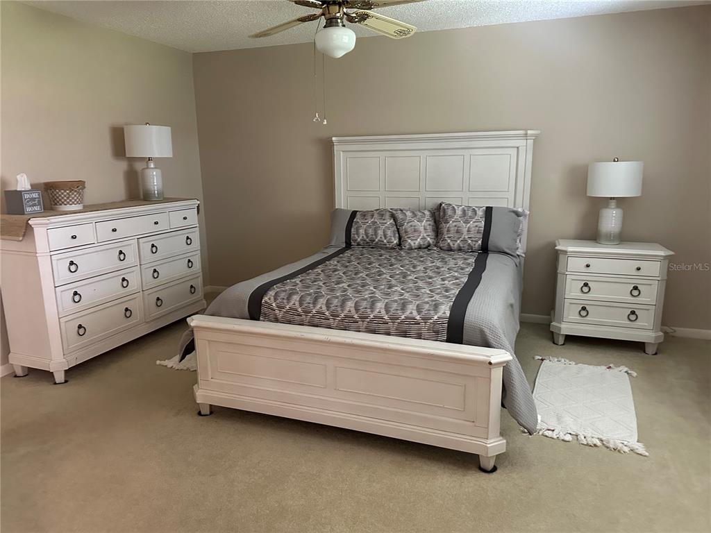 8680 Southwest 94 Lane, Unit G Ocala, FL 34481 - Photo 22 of 24 a bedroom with a bed and a cabinets