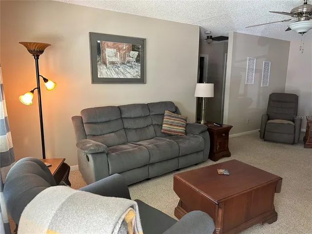 a living room with furniture and a lamp