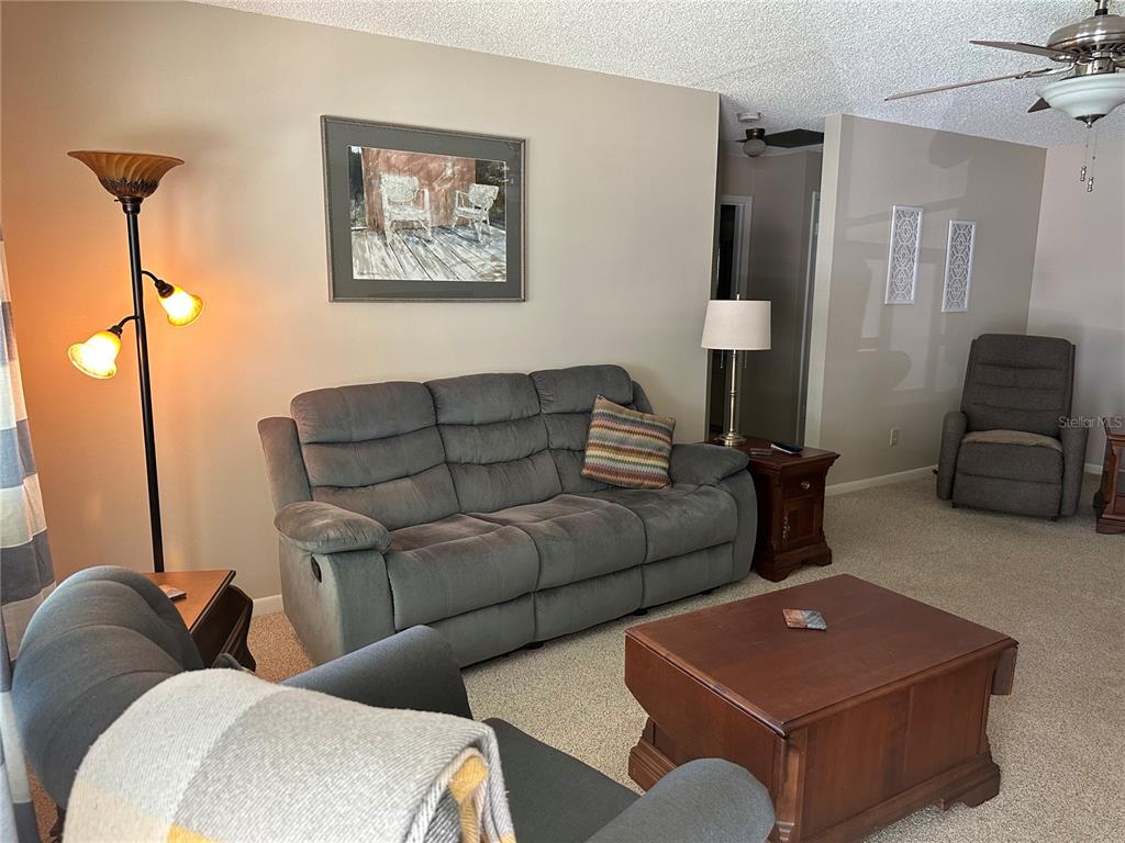 8680 Southwest 94 Lane, Unit G Ocala, FL 34481 - Photo 4 of 24 a living room with furniture and a lamp