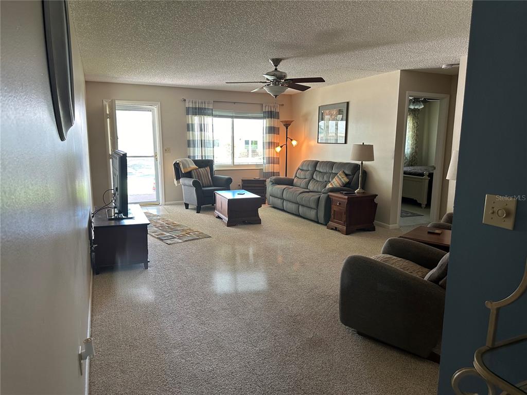 8680 Southwest 94 Lane, Unit G Ocala, FL 34481 - Photo 7 of 24 a living room with furniture and a large window