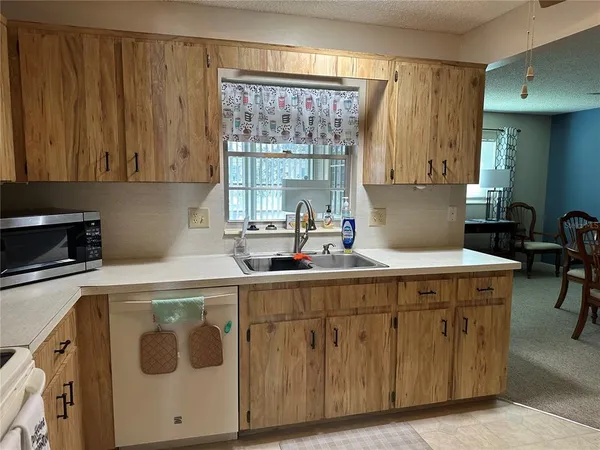 a kitchen with a sink a cabinets and appliances