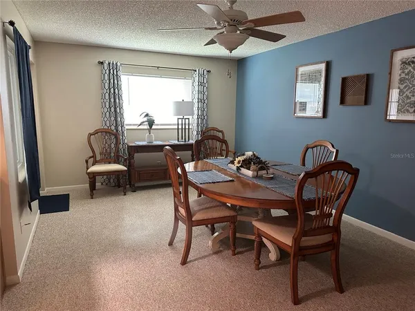 a dining room with furniture and window