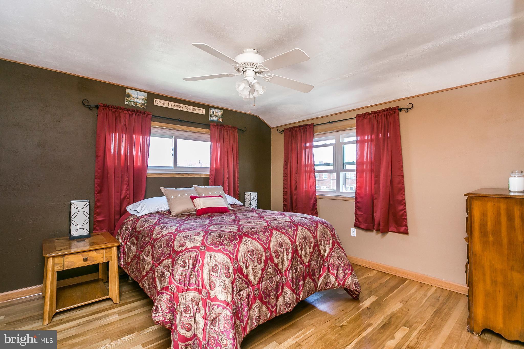 8511 Kings Ridge Road Baltimore, MD 21234 - Photo 12 of 30 a bedroom with a bed and wooden floor