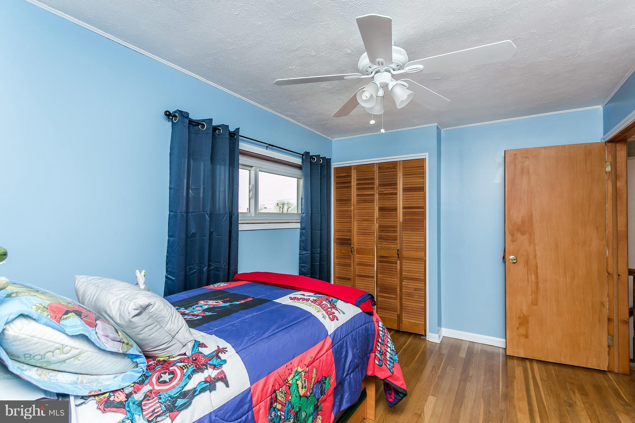 8511 Kings Ridge Road Baltimore, MD 21234 - Photo 16 of 30 a bedroom with a bed a window and wooden floor