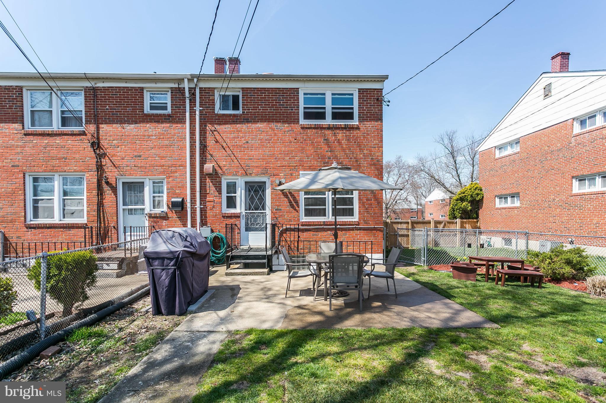 8511 Kings Ridge Road Baltimore, MD 21234 - Photo 27 of 30 a front view of a house with a yard patio and fire pit