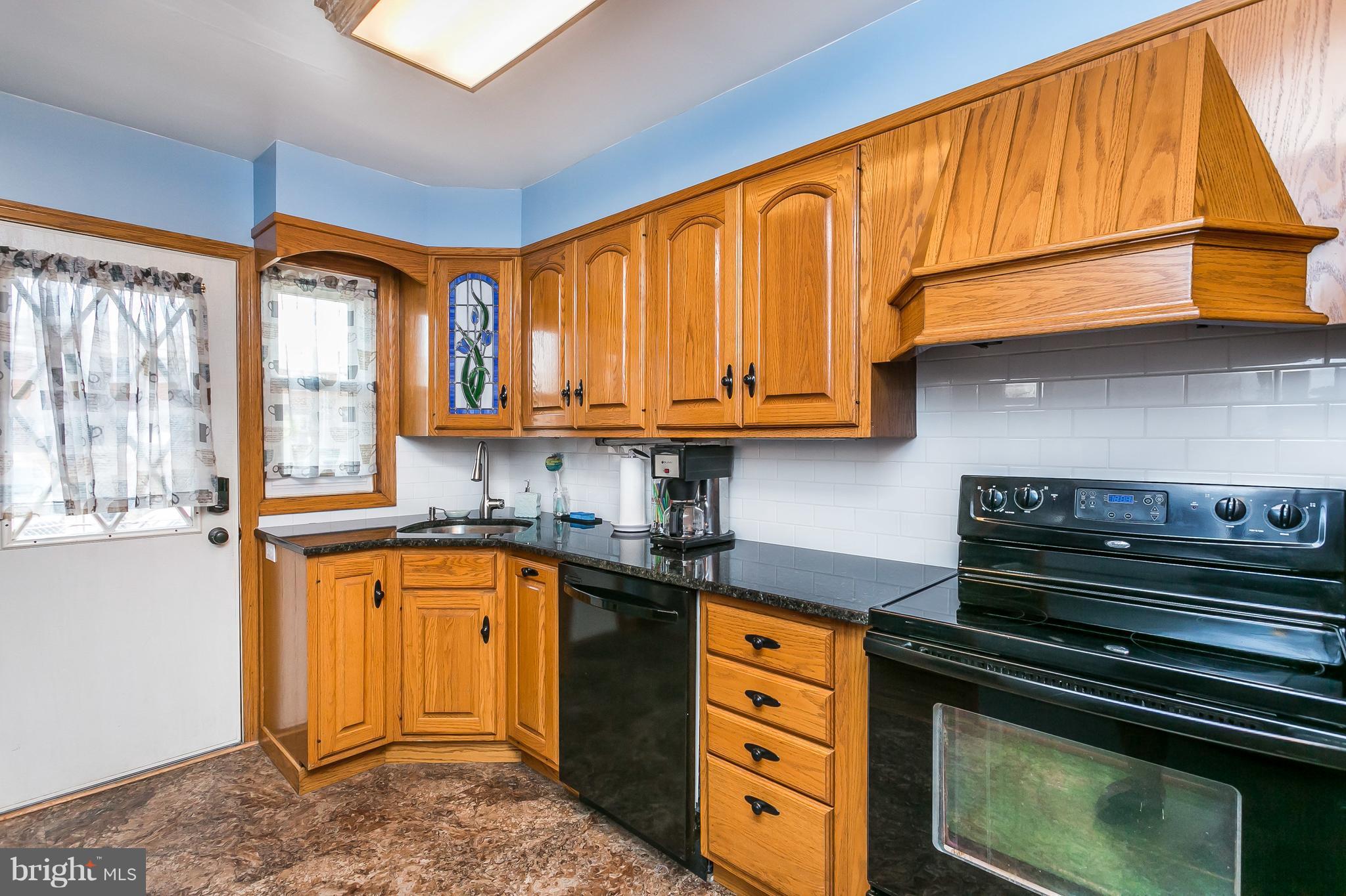 8511 Kings Ridge Road Baltimore, MD 21234 - Photo 9 of 30 a kitchen with stainless steel appliances granite countertop a stove a sink and a microwave