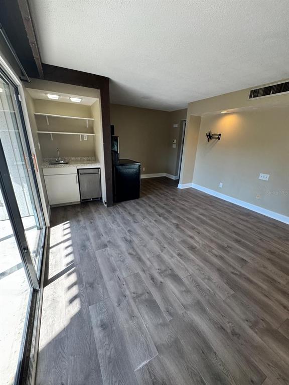 2241 Burnway Road, Unit 2241 Haines City, FL 33844 - Photo 7 of 20 a view of a room with wooden floor and a window