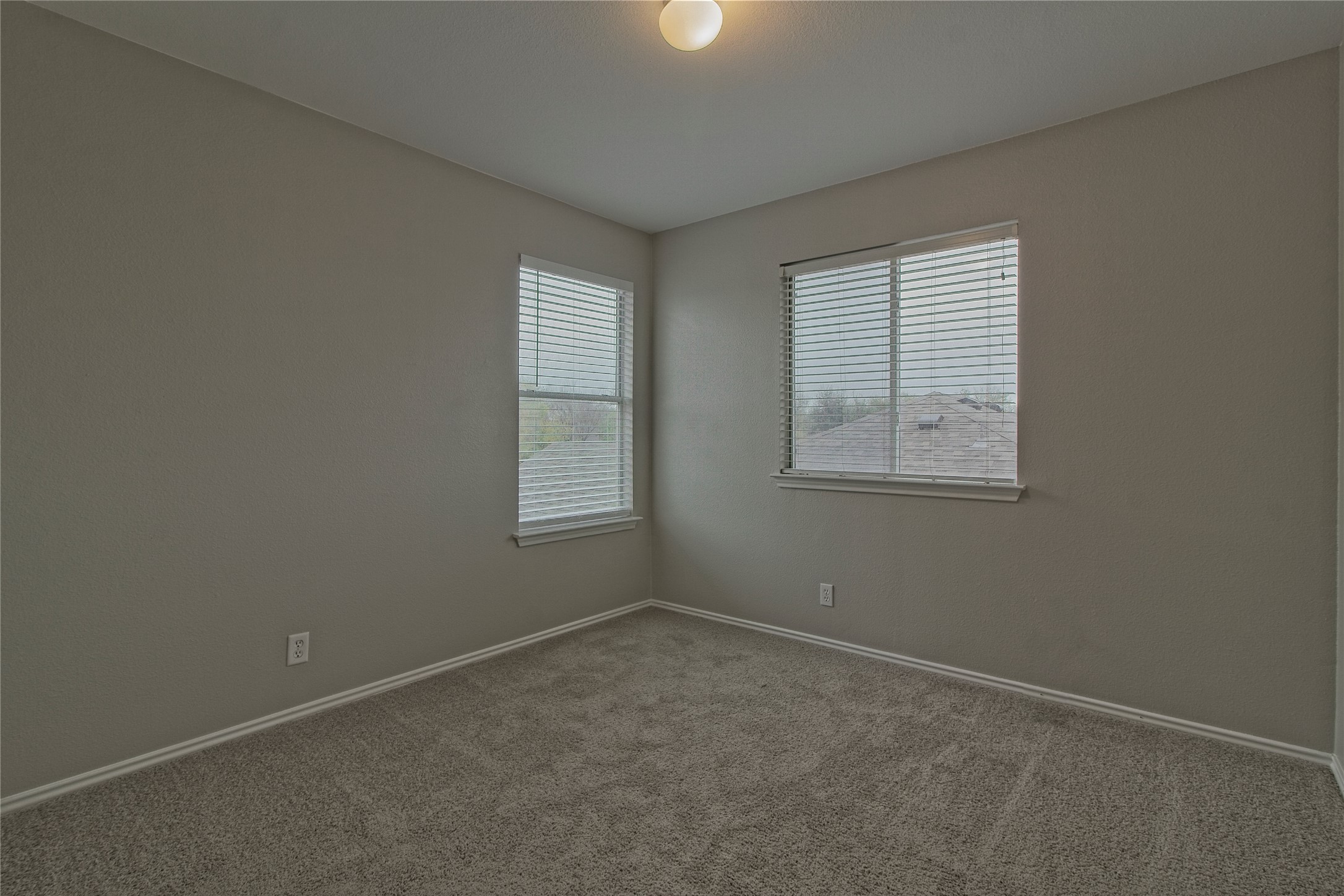 232 Brickyard Lane Jarrell, TX 76537 - Photo 23 of 31 A well-lit bedroom provides a cozy retreat with ample natural light filtering through dual windows.
