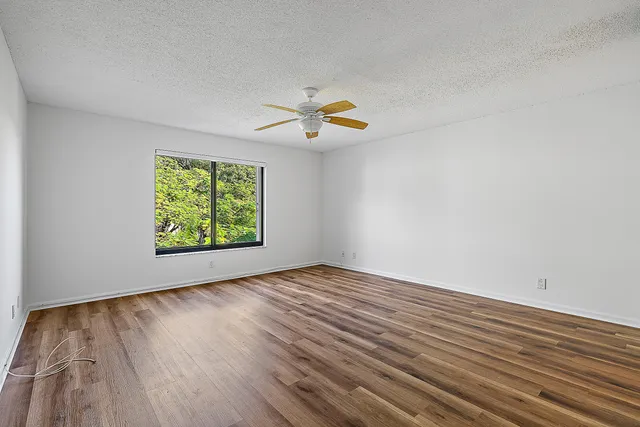 wooden floor in an empty room with a window