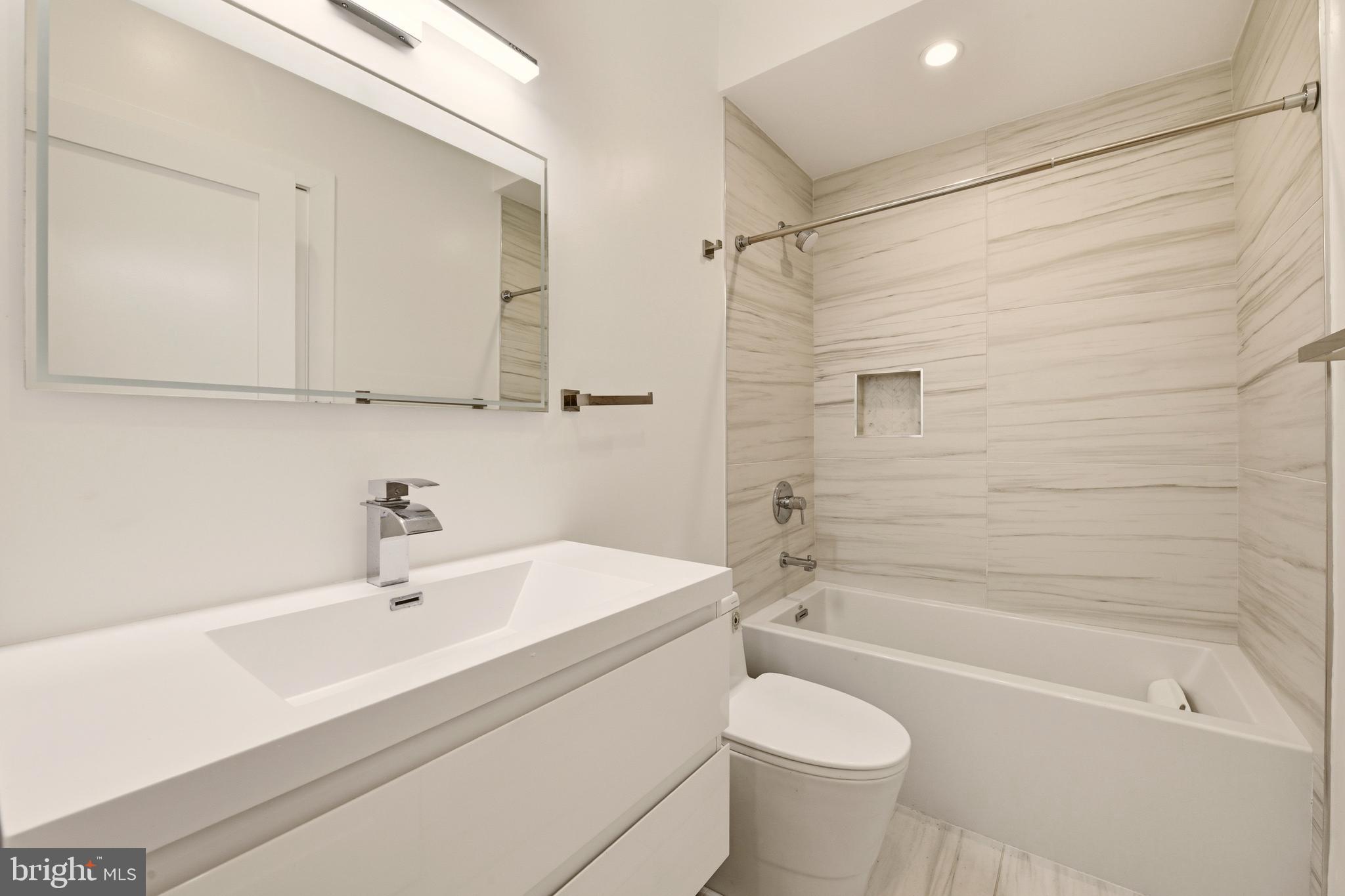 1023 16th Street Northeast, Unit B Washington, DC 20002 - Photo 14 of 25 a bathroom with a sink a toilet and a bathtub