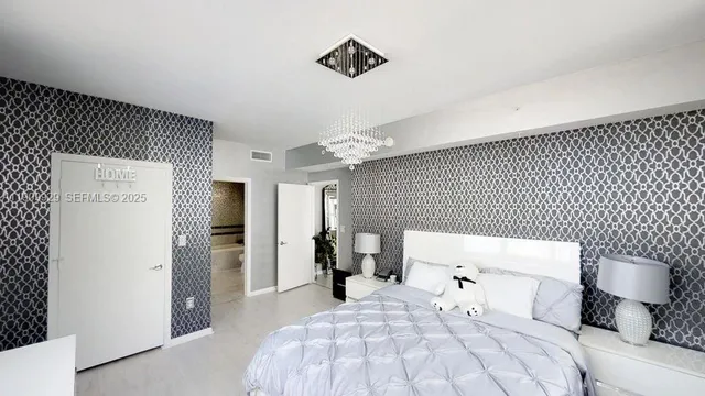 a bedroom with a bed and a refrigerator