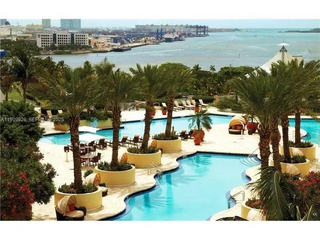 a view of a swimming pool with outdoor seating