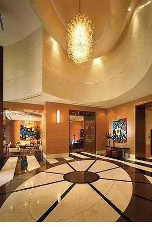 a living room with furniture a chandelier and a large mirror