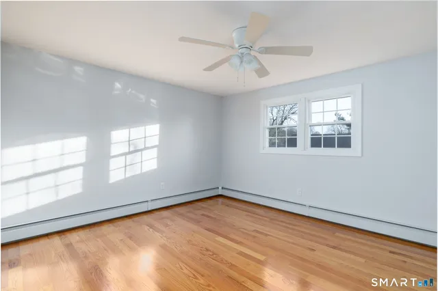wooden floor in an empty room with a window