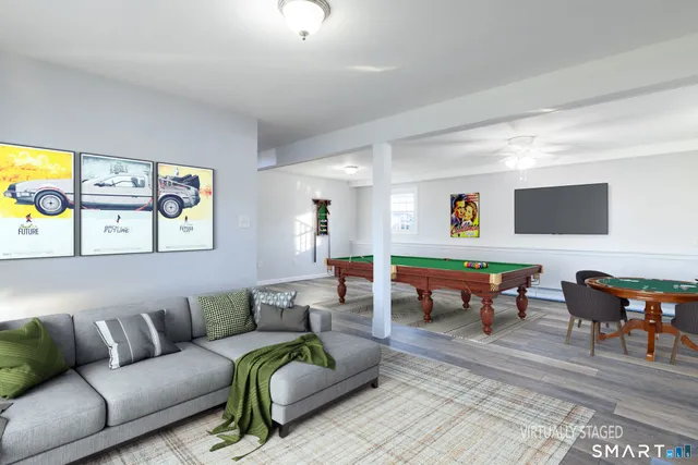 a living room with furniture a rug and a wall painting