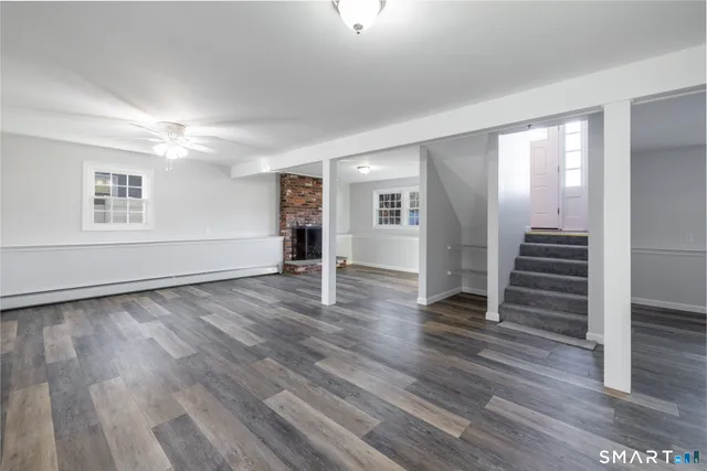 wooden floor in an empty room with a window