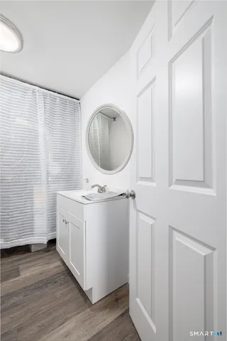 a bathroom with a sink a mirror and vanity