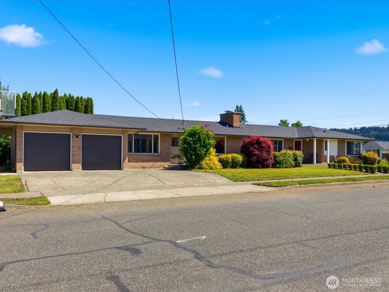 1417 Maple Street Sumner, WA 98390 - Photo 2 of 40 a front view of a house with a yard and garage
