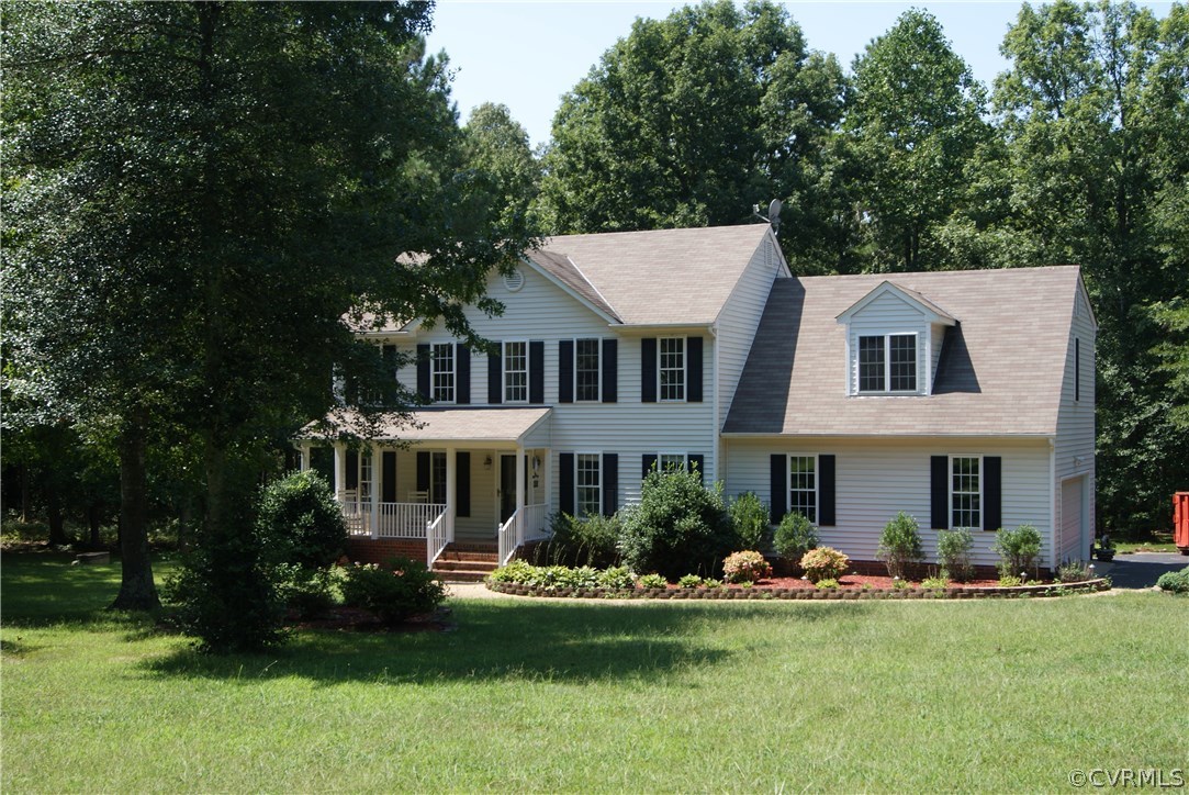 a front view of a house with a garden and swimming pool