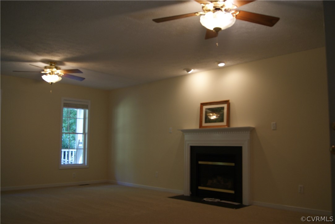9610 Cattail Road Chesterfield, VA 23838 - Photo 11 of 17 a view of a livingroom with a chandelier fan and a fireplace