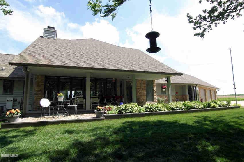 8477 West Mound Road Lena, IL 61048 - Photo 1 of 25 a front view of a house with a garden and plants