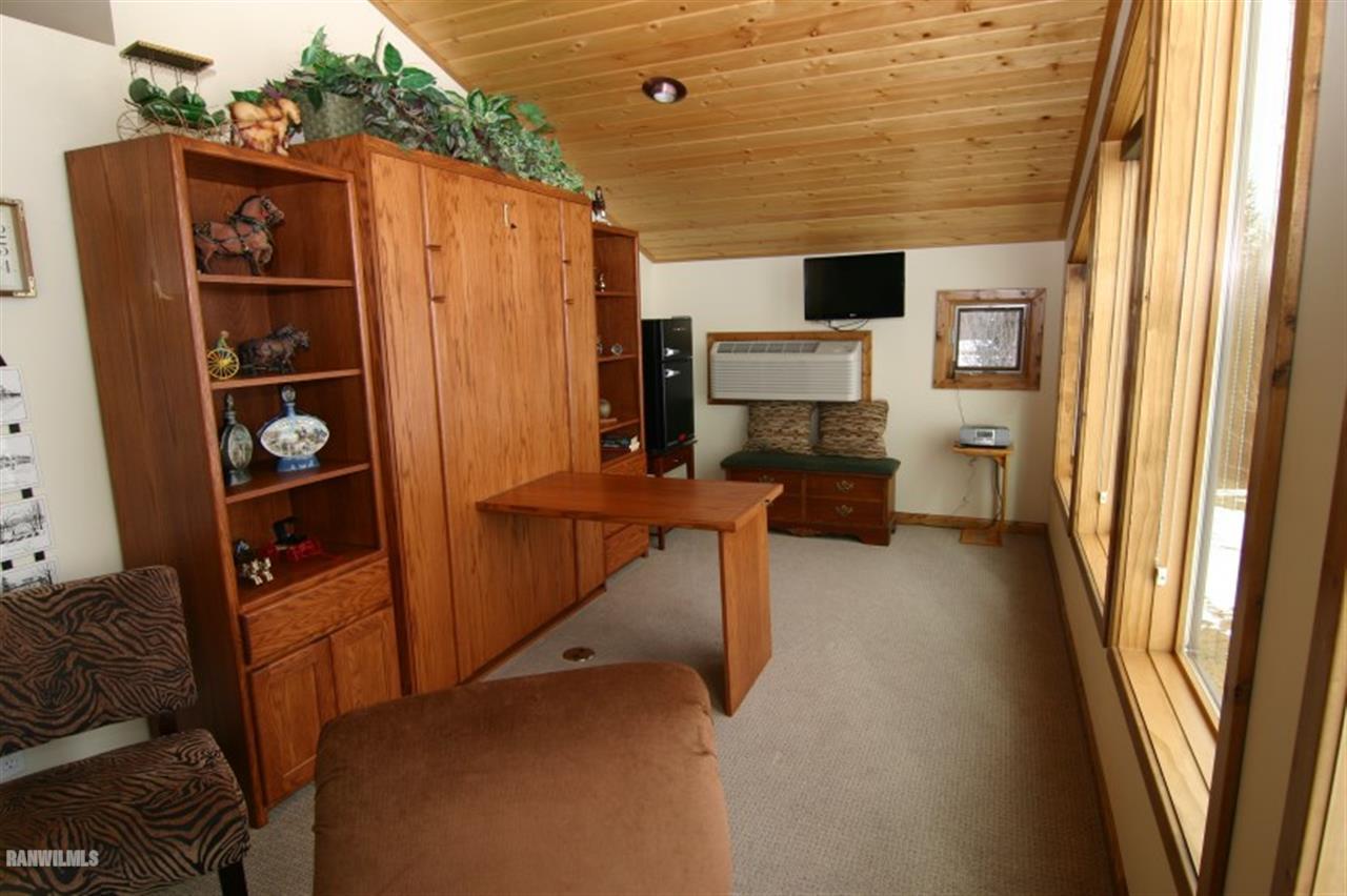 8477 West Mound Road Lena, IL 61048 - Photo 12 of 25 a view of walk in closet with clothes and shoes