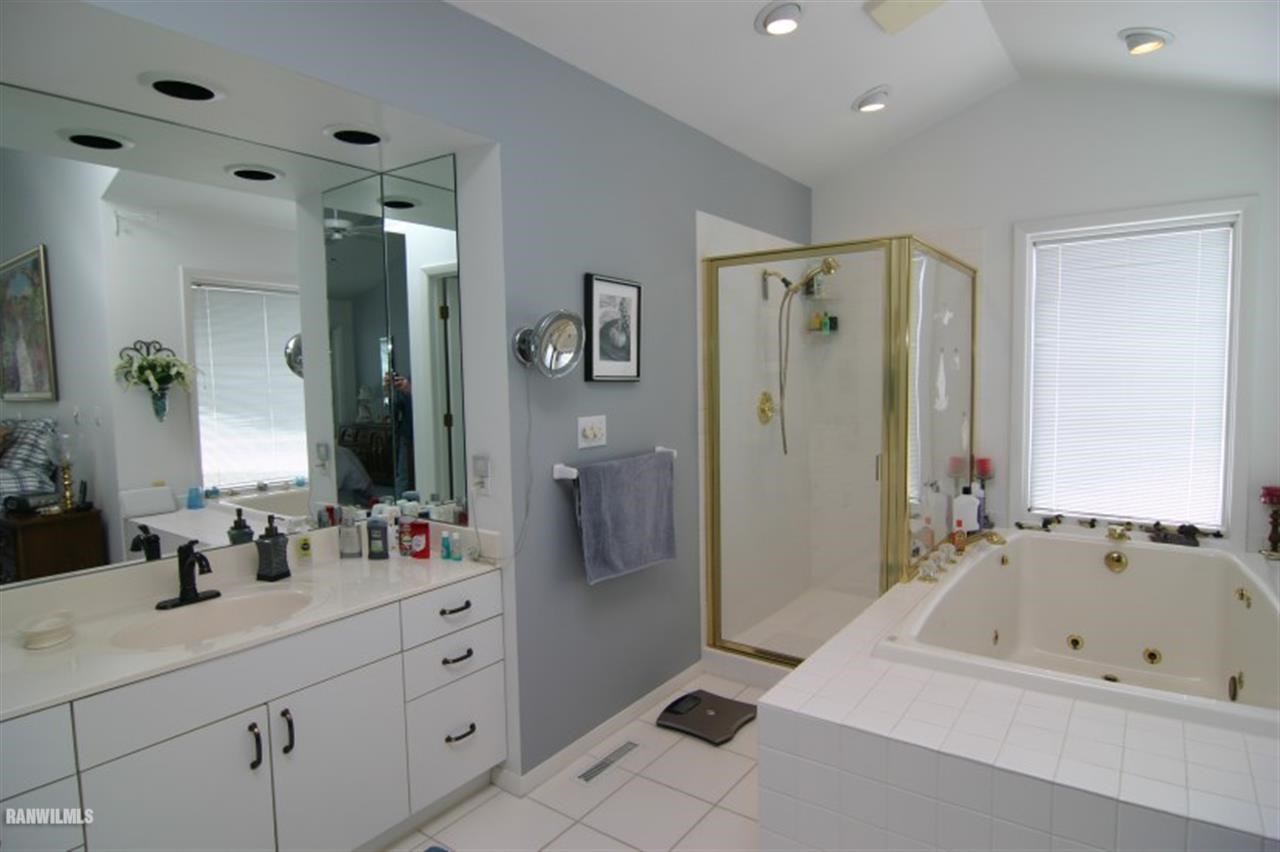 8477 West Mound Road Lena, IL 61048 - Photo 18 of 25 a spacious bathroom with a tub sink and mirror
