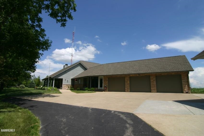 8477 West Mound Road Lena, IL 61048 - Photo 4 of 25 a front view of a house with a garden