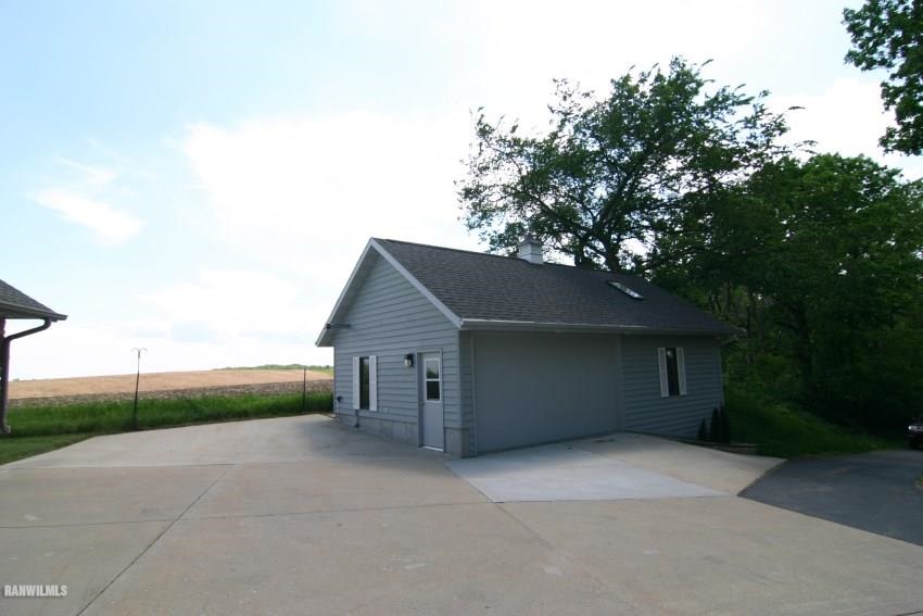 8477 West Mound Road Lena, IL 61048 - Photo 5 of 25 front view of a house with a yard and garage