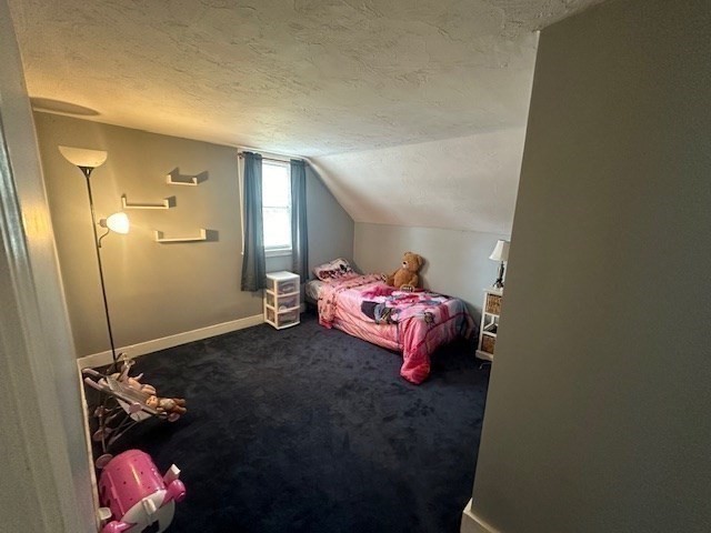 84 Lincoln Street Hudson, MA 01749 - Photo 11 of 26 a bedroom with a bed and a chandelier