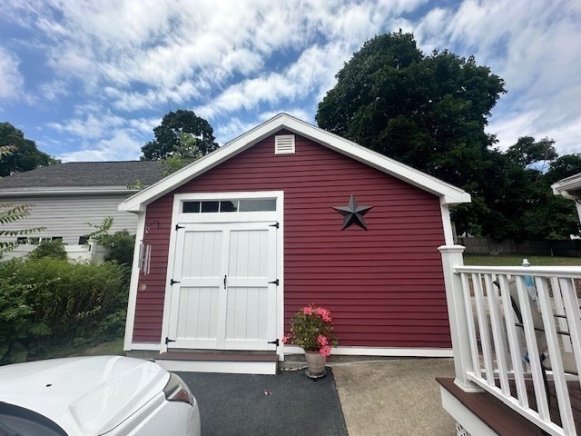 84 Lincoln Street Hudson, MA 01749 - Photo 21 of 26 a front view of a house with a garage
