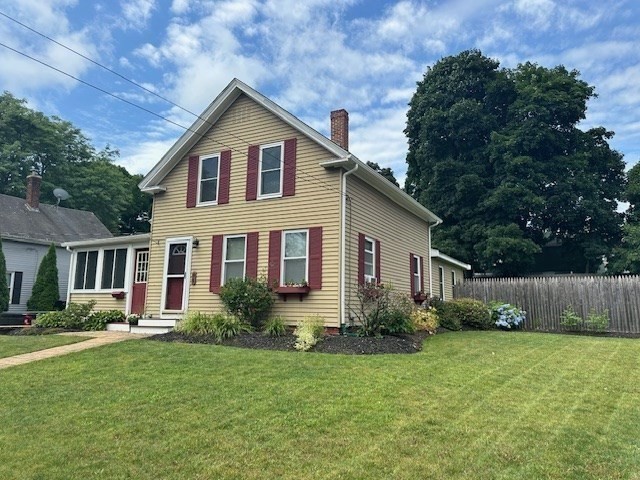 84 Lincoln Street Hudson, MA 01749 - Photo 3 of 26 a front view of house with yard and green space