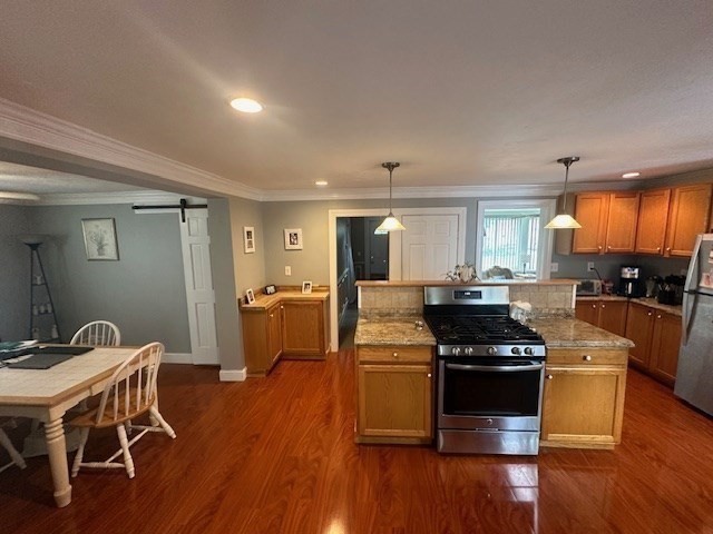 84 Lincoln Street Hudson, MA 01749 - Photo 6 of 26 a kitchen with stainless steel appliances wooden floors wooden cabinets dining table and chairs