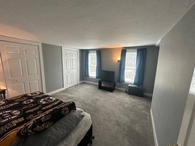 84 Lincoln Street Hudson, MA 01749 - Photo 8 of 26 a bedroom with a bed and window