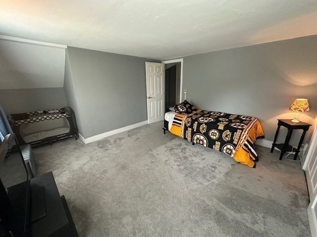 84 Lincoln Street Hudson, MA 01749 - Photo 10 of 26 a bedroom with furniture and a window