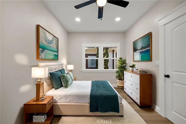 a bedroom with a large bed and a flat screen tv