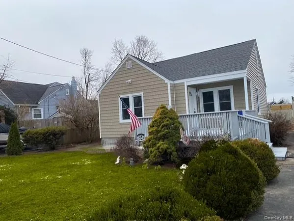 a front view of a house with a garden and plants