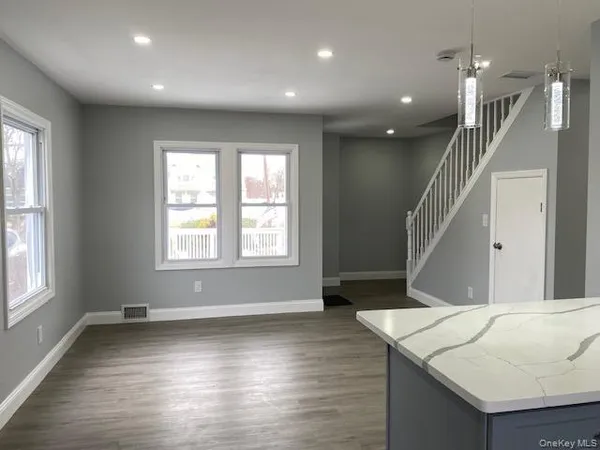 an entryway and livingroom with furniture