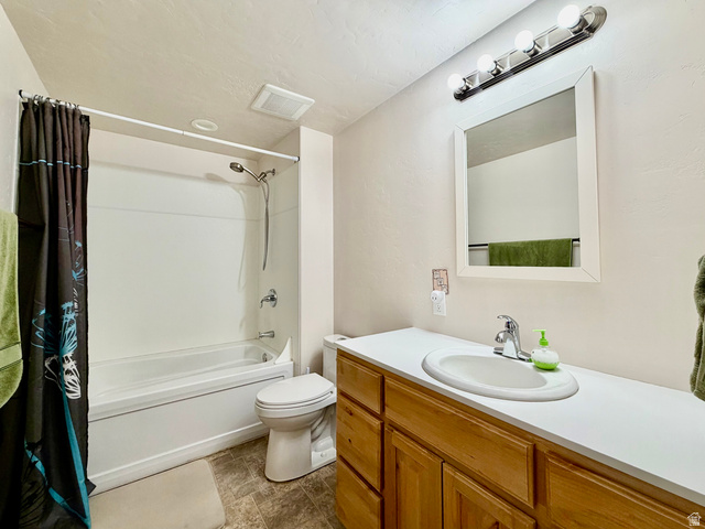 1204 South 1150th Street West Payson, UT 84651 - Photo 13 of 26 Basement Full Bathroom featuring a full tub/shower combination with chrome fixtures, a wood-finish vanity with a white countertop and integrated sink, and an overhead vanity light bar