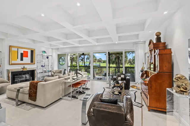 a living room with furniture kitchen view and a table