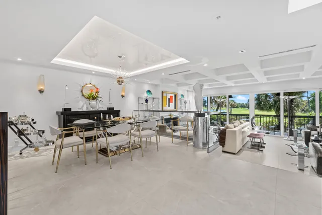 a living room with patio furniture and a floor to ceiling window