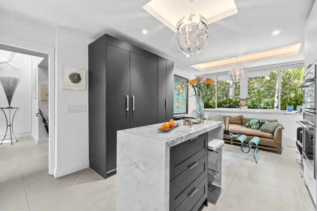 a spacious bedroom with a bed a couch and a large window