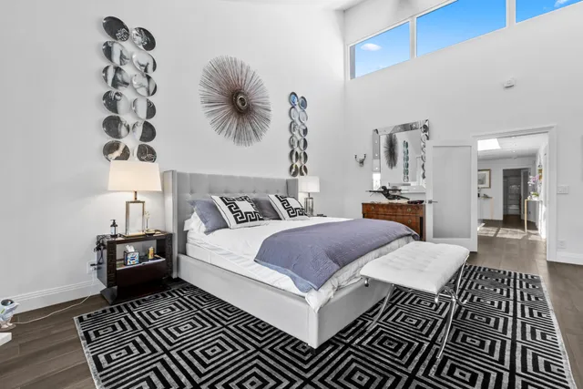 a bathroom with a granite countertop sink and a large mirror