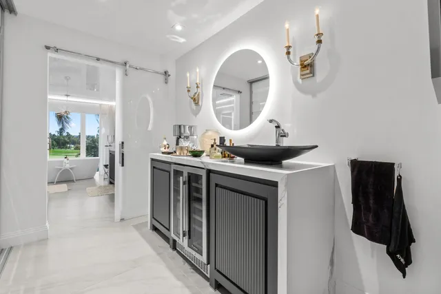 a bathroom with a sink vanity granite shower and a mirror