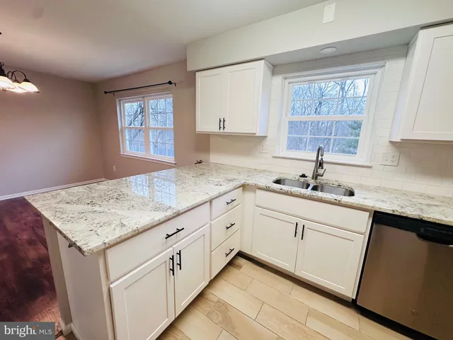a kitchen with sink cabinets and window