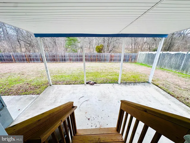 a view of a room with wooden floor and fence