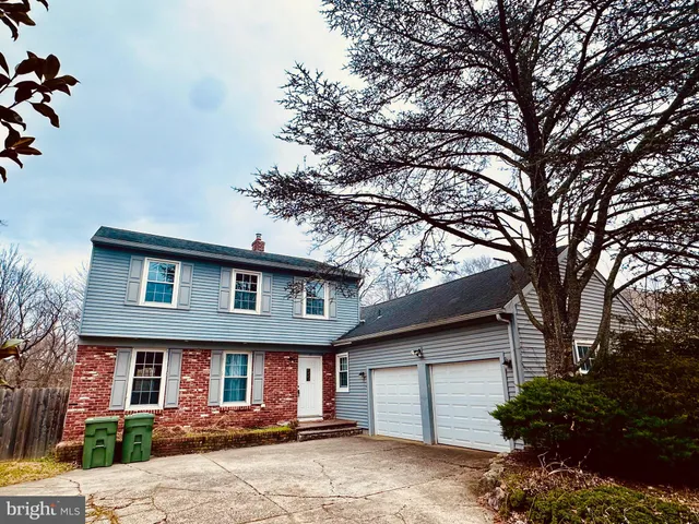 a front view of a house with a tree